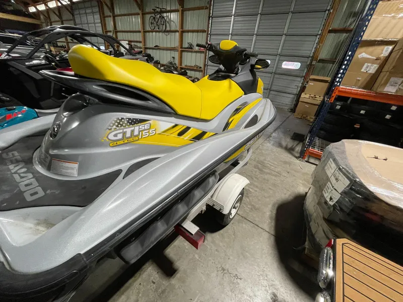 Slide: The Image of 2007 Sea-Doo GTI SE 155 jet ski with yellow seat in a storage facility. - 11