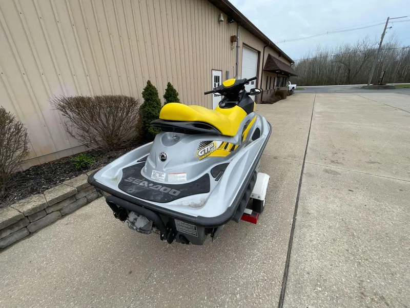 Slide: The Image of 2007 Sea-Doo GTI SE 155 jet ski parked on concrete near a building. - 3