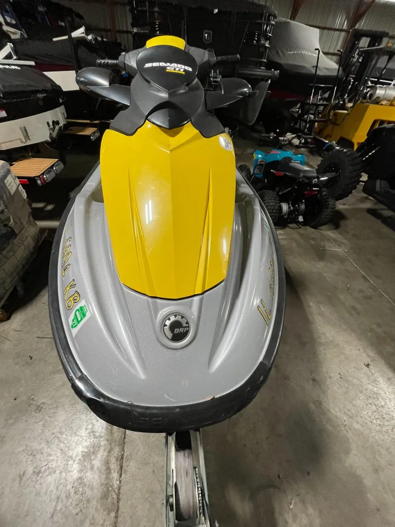 Slide: The Image of 2007 Sea-Doo GTI™ SE 155 jet ski with yellow and gray design in a storage area. - 8