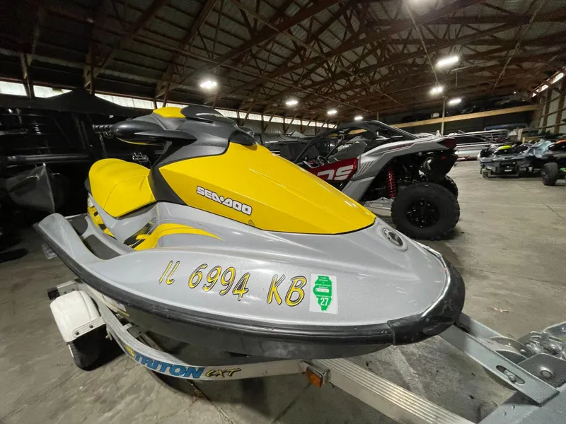 Slide: The Image of 2007 Sea-Doo GTI SE 155 jet ski in a warehouse, yellow and gray design. - 9