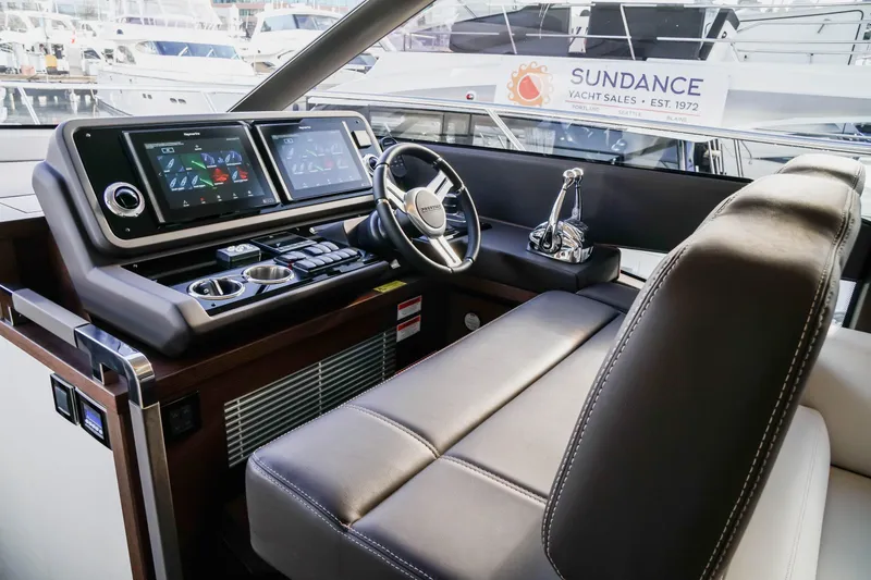 Slide: The Image of Luxurious 2025 Prestige 590 yacht cockpit with modern controls and leather seating. - 11