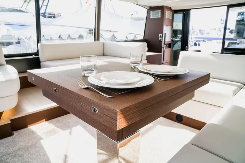 Slide: The Image of Luxurious interior of 2025 Prestige 590 yacht with elegant dining setup. - 13