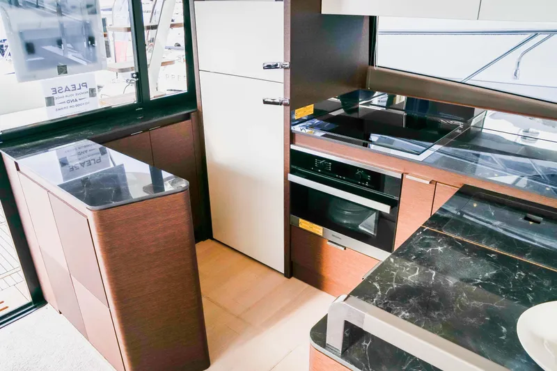 Slide: The Image of Modern kitchen interior of 2025 Prestige 590 yacht with sleek appliances and marble countertops. - 15