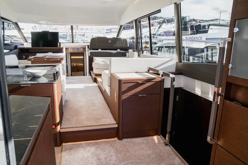 Slide: The Image of Luxurious interior of a 2025 Prestige 590 yacht with modern furnishings and panoramic windows. - 6