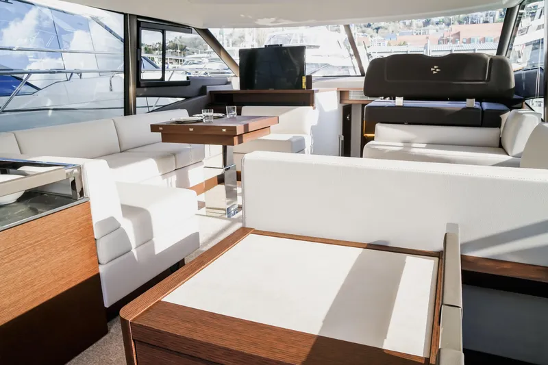 Slide: The Image of Luxurious interior of 2025 Prestige 590 yacht with modern seating and elegant design. - 9