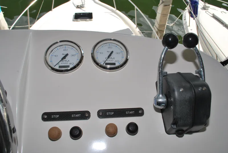 Slide: The Image of Control panel of a 2005 Stamas 370 Express boat with gauges and throttle levers. - 11