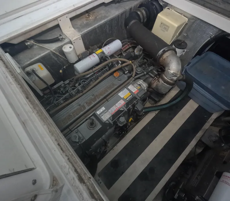 Slide: The Image of Engine compartment of a 2005 Stamas 370 Express boat, showcasing mechanical components. - 19