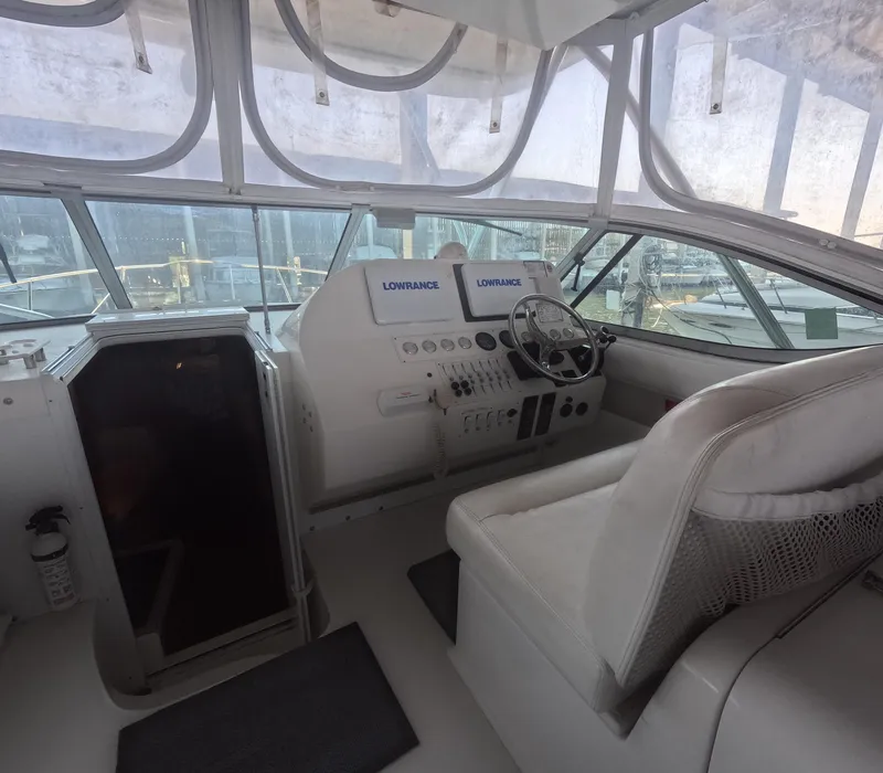Slide: The Image of 2005 Stamas 370 Express boat cockpit with steering wheel and navigation equipment. - 24