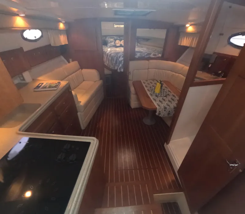 Slide: The Image of Interior of a 2005 Stamas 370 Express yacht with wood flooring and cozy seating. - 27