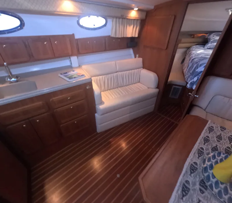 Slide: The Image of Interior of 2005 Stamas 370 Express yacht with wood flooring and cozy seating area. - 31