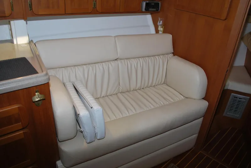 Slide: The Image of 2005 Stamas 370 Express interior with beige leather seating and wooden cabinetry. - 33