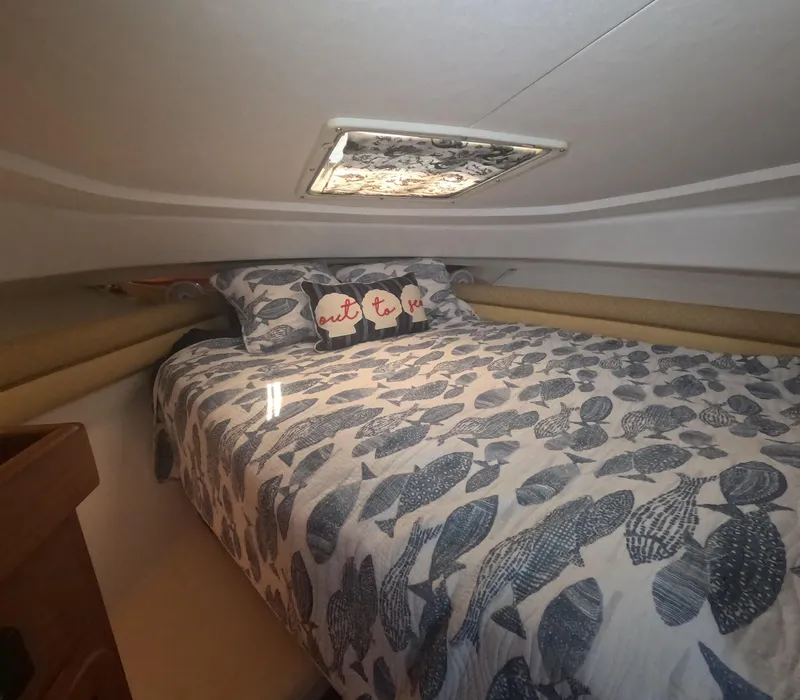 Slide: The Image of Cozy cabin interior of 2005 Stamas 370 Express with patterned bedding and decorative pillows. - 44