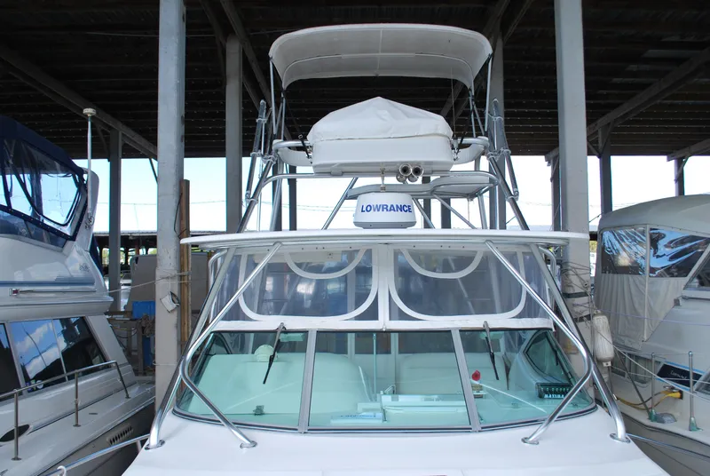 Slide: The Image of 2005 Stamas 370 Express boat docked in a covered marina. - 5