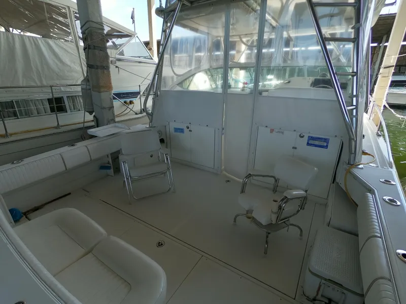 Slide: The Image of 2005 Stamas 370 Express boat interior with seating and fishing chairs. - 9