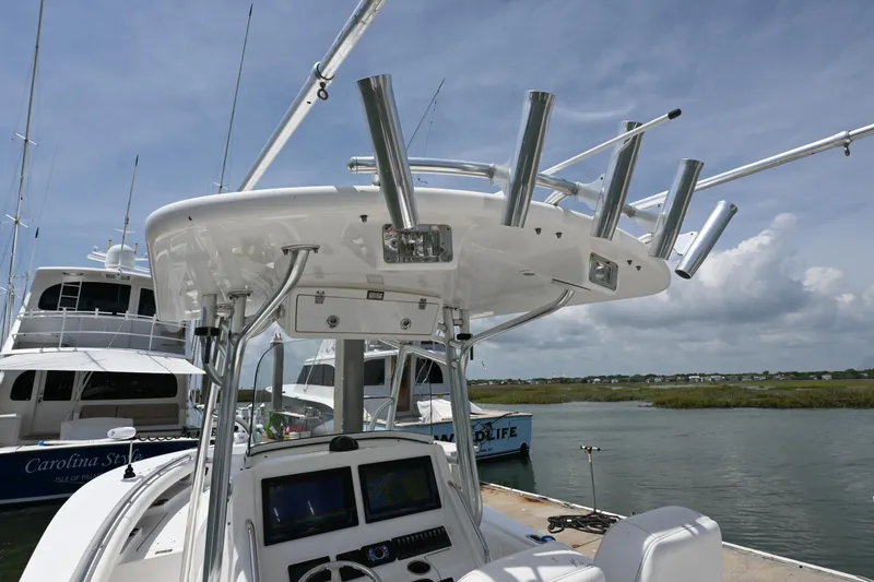 Slide: The Image of 2012 Regulator 28 Forward Seating boat with rod holders and navigation equipment. - 10