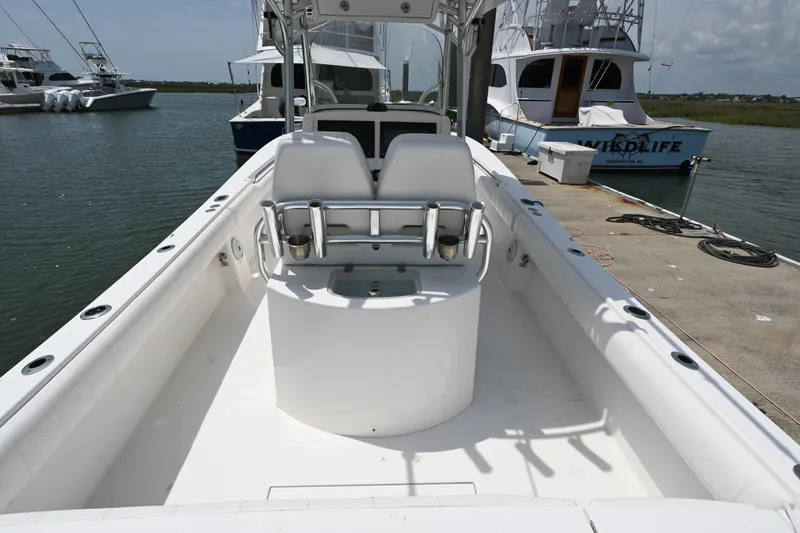Slide: The Image of 2012 Regulator 28 Forward Seating boat docked at marina. - 16