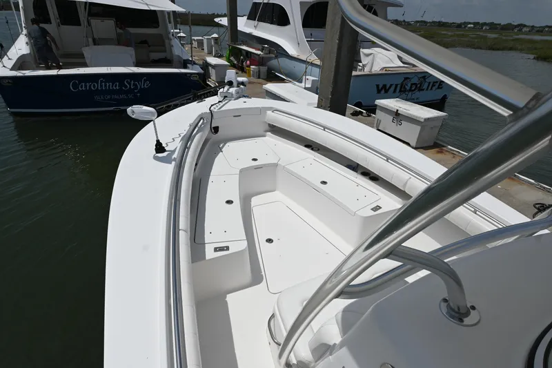 Slide: The Image of 2012 Regulator 28 Forward Seating boat docked, showcasing spacious seating and sleek design. - 17