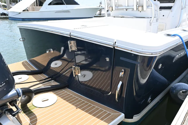 Slide: The Image of 2012 Regulator 28 Forward Seating boat docked, featuring sleek design and modern fittings. - 18