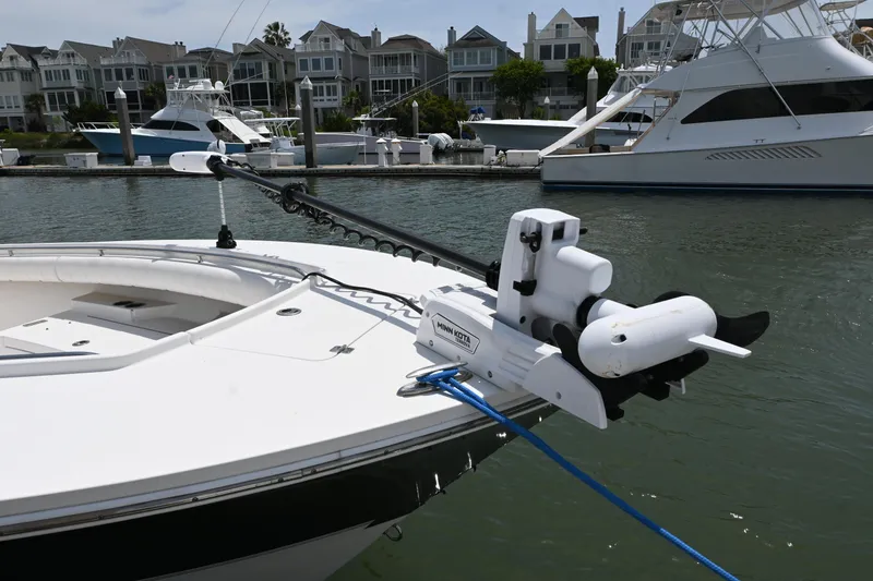 Slide: The Image of 2012 Regulator 28 Forward Seating boat with trolling motor docked in marina. - 6