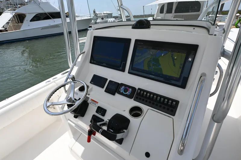 Slide: The Image of 2012 Regulator 28 Forward Seating boat dashboard with dual screens and controls. - 9