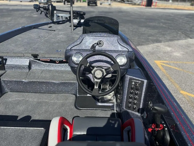 Slide: The Image of Interior of a 2025 Phoenix 920 Elite boat, featuring a sleek steering console. - 10