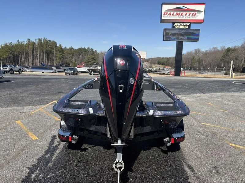 Slide: The Image of 2025 Phoenix 920 Elite boat with powerful engine, parked outdoors at dealership. - 4