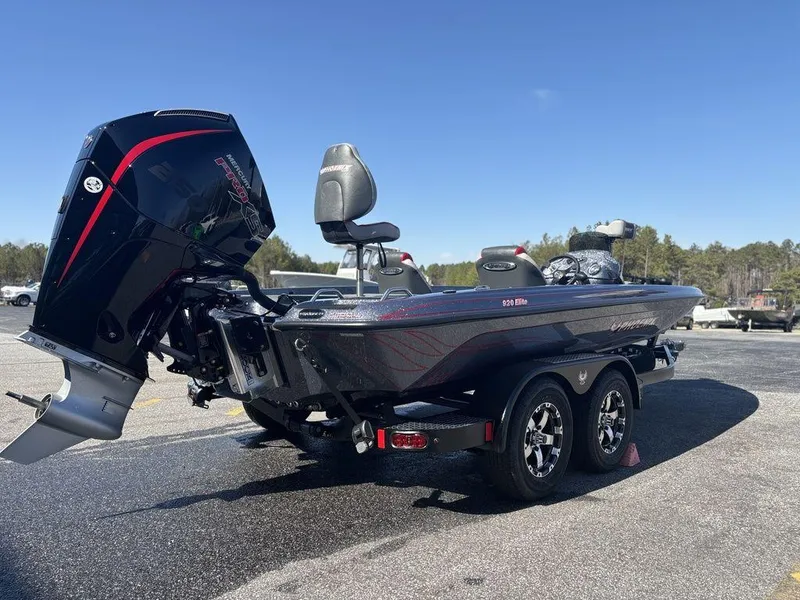 Slide: The Image of 2025 Phoenix 920 Elite boat on trailer, featuring powerful outboard motor, parked outdoors. - 5