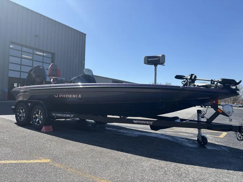 Slide: The Image of 2025 Phoenix 920 Elite boat on trailer, parked outside a building. - 7