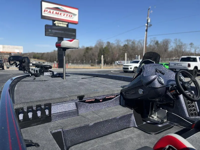 Slide: The Image of 2025 Phoenix 920 Elite boat interior at dealership, featuring steering console and seating. - 8