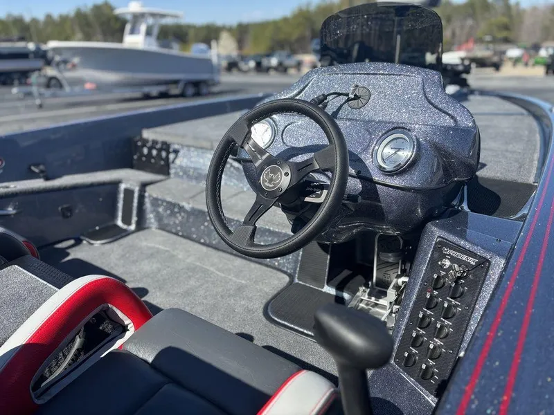 Slide: The Image of 2025 Phoenix 920 Elite boat interior with steering wheel and control panel. - 9