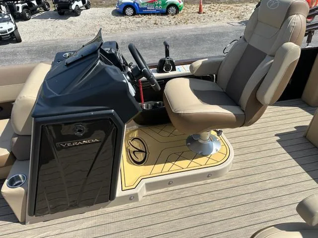 Slide: The Image of 2025 Veranda Relax VLC VR25VLC boat helm with beige captain's chair and control panel. - 10