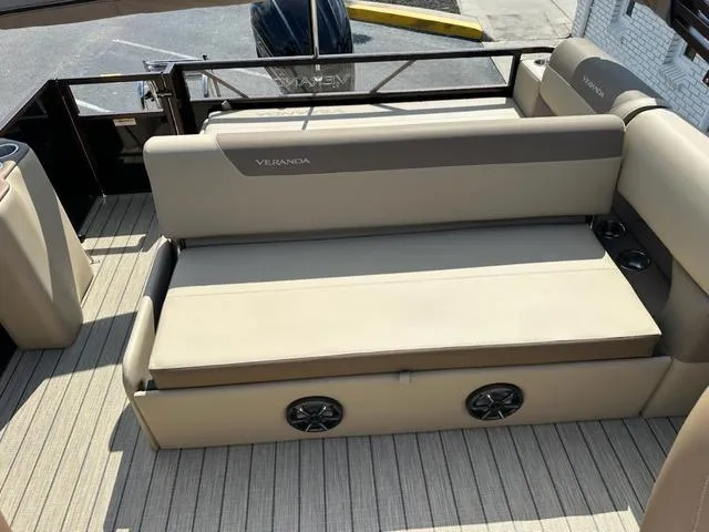 Slide: The Image of 2025 Veranda Relax VLC VR25VLC boat interior with beige seating and built-in speakers. - 12