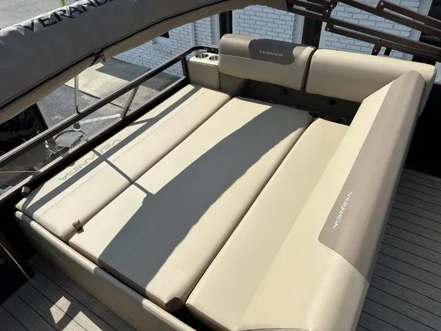 Slide: The Image of 2025 Veranda Relax VLC VR25VLC boat interior with beige seating and cup holders. - 13