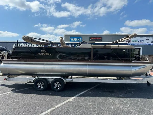 Slide: The Image of 2025 Veranda Relax VLC VR25VLC pontoon boat on trailer under blue sky. - 3