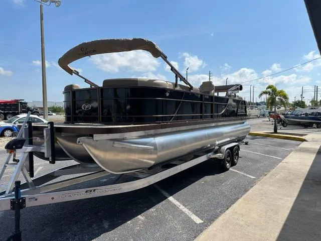Slide: The Image of 2025 Veranda Relax VLC VR25VLC pontoon boat on trailer in sunny parking lot. - 6