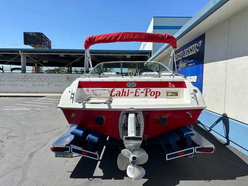 Slide: The Image of 1991 Cobalt Condurre 222 boat with red canopy, parked on trailer. - 11