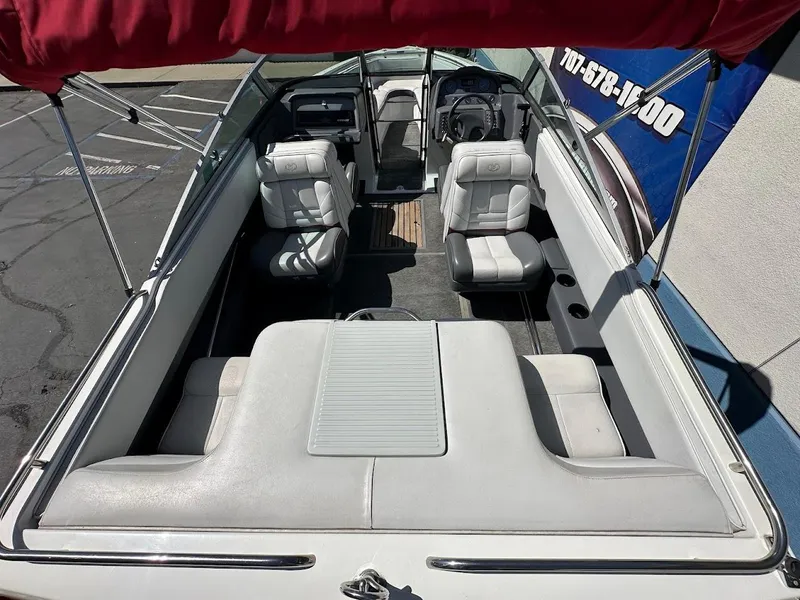 Slide: The Image of 1991 Cobalt Condurre 222 boat interior with white seating and red canopy. - 12