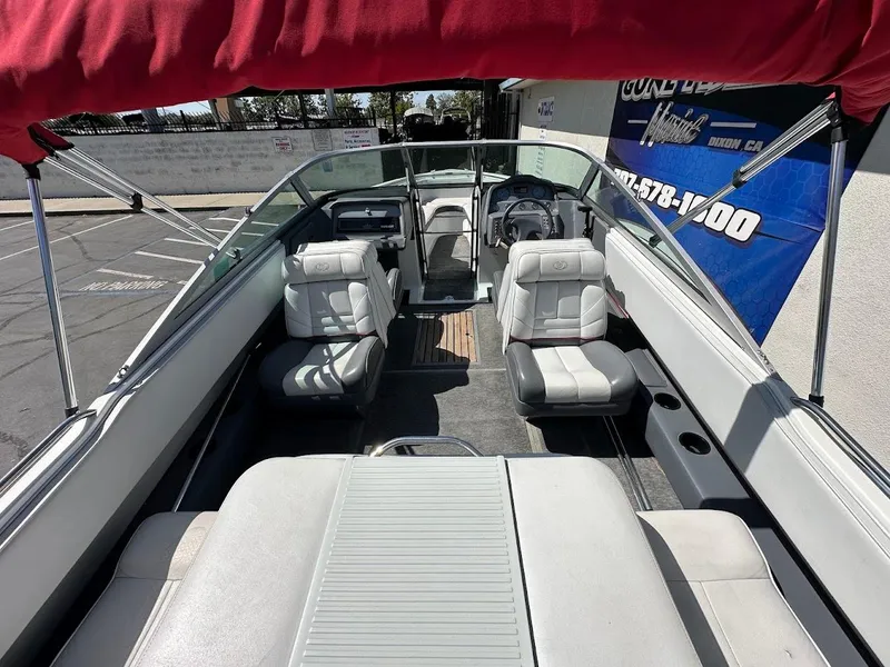 Slide: The Image of 1991 Cobalt Condurre 222 boat interior with white seating and red canopy. - 13