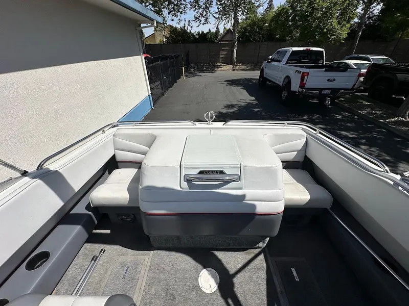 Slide: The Image of 1991 Cobalt Condurre 222 boat interior with white seating and storage compartment. - 14