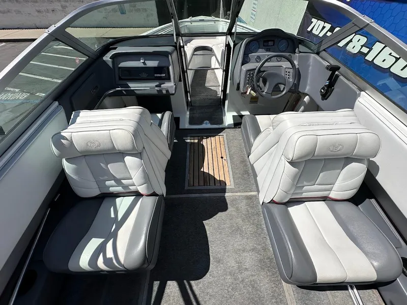 Slide: The Image of 1991 Cobalt Condurre 222 boat interior with gray and white seating, steering wheel, and dashboard. - 15