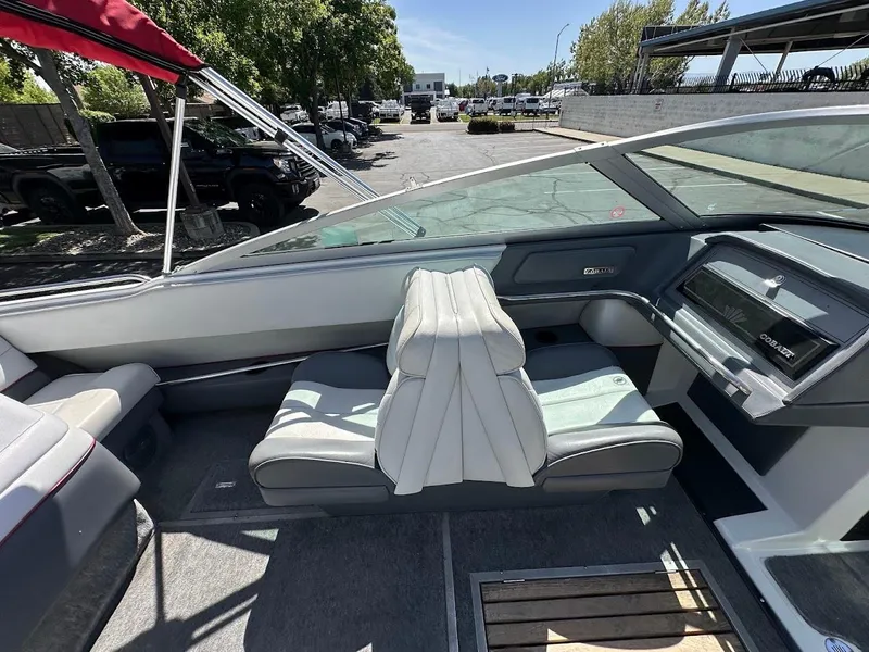 Slide: The Image of 1991 Cobalt Condurre 222 boat interior with gray seating and dashboard, parked outdoors. - 17