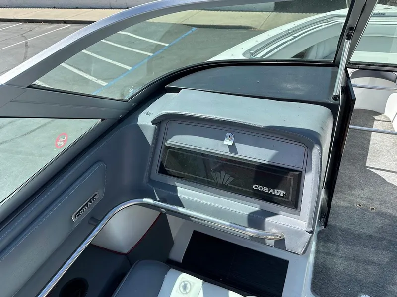 Slide: The Image of 1991 Cobalt Condurre 222 boat interior with dashboard and seating, featuring sleek design elements. - 19