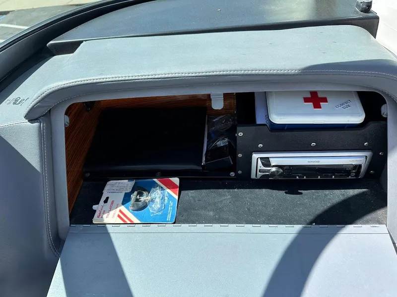 Slide: The Image of Glove compartment of 1991 Cobalt Condurre 222 with first aid kit and stereo system. - 20
