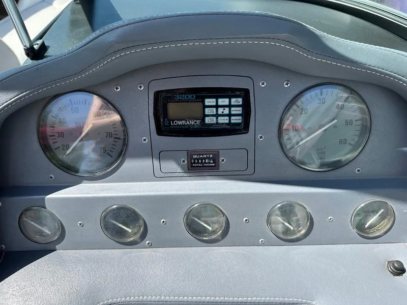 Slide: The Image of Dashboard of a 1991 Cobalt Condurre 222 boat with gauges and Lowrance display. - 24