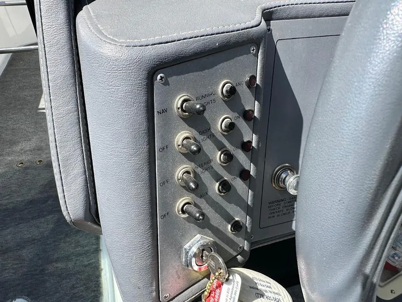 Slide: The Image of Control panel of a 1991 Cobalt Condurre 222 boat with switches and ignition key. - 26