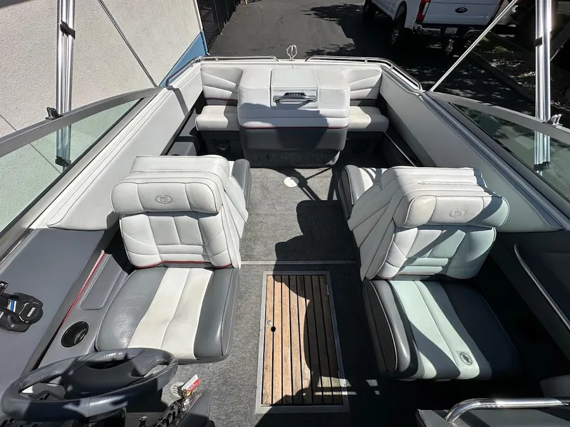 Slide: The Image of Interior of a 1991 Cobalt Condurre 222 boat with gray seating and wood accents. - 28
