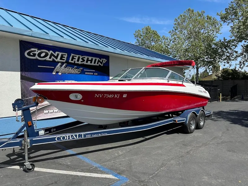 Slide: The Image of Red 1991 Cobalt Condurre 222 boat on trailer, parked outside "Gone Fishin'" store. - 3