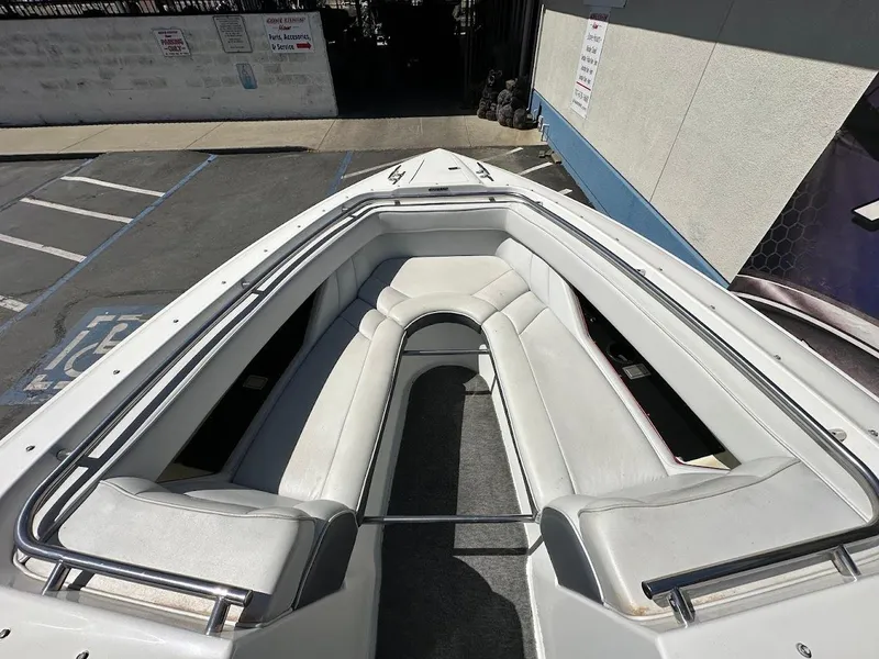 Slide: The Image of 1991 Cobalt Condurre 222 boat with white interior seating, docked in a parking area. - 30