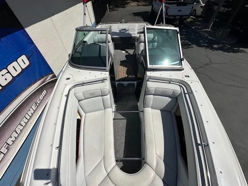 Slide: The Image of 1991 Cobalt Condurre 222 boat interior with white seating and open deck layout. - 31