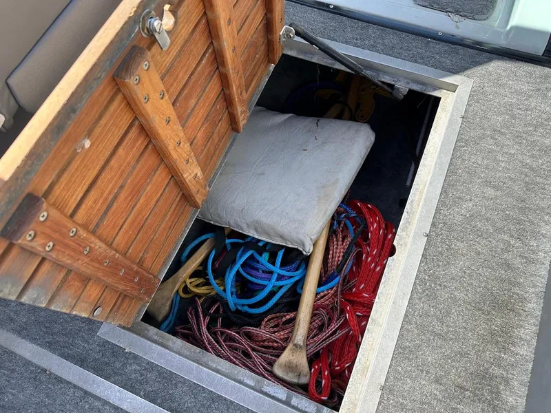 Slide: The Image of Storage compartment in 1991 Cobalt Condurre 222 boat with ropes and cushion. - 34